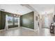 Open dining area with wood-look tile floors and modern chandelier at 14786 Horse Trot Rd, Lithia, FL 33547