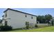 Side exterior view of two-story home highlighting the manicured lawn and private fenced backyard at 14786 Horse Trot Rd, Lithia, FL 33547