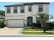 Charming two-story home with a manicured lawn and a two-car garage at 14786 Horse Trot Rd, Lithia, FL 33547