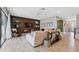 Open-concept living room with stylish decor, comfortable seating, and view to entryway at 14786 Horse Trot Rd, Lithia, FL 33547