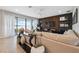 Spacious living room with large sectional, modern accent wall, and sliding glass doors at 14786 Horse Trot Rd, Lithia, FL 33547