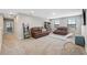 Bright living room with soft carpet, comfortable couches, a TV, and shelving for storage and decor at 14786 Horse Trot Rd, Lithia, FL 33547