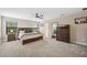 Primary bedroom featuring a ceiling fan, carpeted floor, and a large window for natural light at 14786 Horse Trot Rd, Lithia, FL 33547