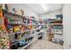 Walk-in pantry features ample shelving for storing food items and kitchen supplies at 14786 Horse Trot Rd, Lithia, FL 33547