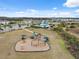 Community playground with swings, slides, and other equipment with shaded seating nearby at 14786 Horse Trot Rd, Lithia, FL 33547