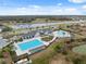 Community pool with lounge chairs and a splash pad on a sunny day near the river at 14786 Horse Trot Rd, Lithia, FL 33547