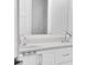 Bathroom with double sinks, quartz countertops, white shaker cabinets, and modern fixtures at 200 Cordova Ne Blvd, St Petersburg, FL 33704