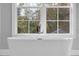Spa-like bathroom featuring a standalone tub and a large window with outdoor views at 200 Cordova Ne Blvd, St Petersburg, FL 33704