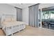 Bright bedroom with a king bed, light walls, and access to the private lanai at 200 Cordova Ne Blvd, St Petersburg, FL 33704