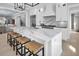 A well-appointed kitchen island features a marble countertop, stainless steel appliances, and seating with barstools at 200 Cordova Ne Blvd, St Petersburg, FL 33704