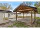 Backyard view of the covered patio area, grassy area and the back of the house at 4420 Pompano Se Dr, St Petersburg, FL 33705