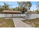 Covered patio and shed in the fenced backyard with a brick path leading to the patio at 4420 Pompano Se Dr, St Petersburg, FL 33705