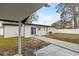 Backyard featuring a sliding glass door and walkway to the covered patio at 4420 Pompano Se Dr, St Petersburg, FL 33705
