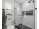Modern bathroom shower with stylish tilework, glass door, and a built-in niche at 4420 Pompano Se Dr, St Petersburg, FL 33705