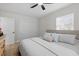 Bright bedroom featuring a ceiling fan, natural light from the window, and a comfortable bed at 4420 Pompano Se Dr, St Petersburg, FL 33705