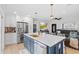 Bright kitchen with stainless appliances, a large island with a white countertop and bar stool seating at 4420 Pompano Se Dr, St Petersburg, FL 33705