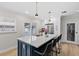 Modern kitchen with an island, barstool seating, stainless steel appliances, and wood floors at 4420 Pompano Se Dr, St Petersburg, FL 33705