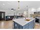 Modern kitchen with large island, pendant lighting, stainless steel appliances, and an open view to the living room at 4420 Pompano Se Dr, St Petersburg, FL 33705