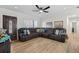 Spacious living room with wood floors, a large sectional sofa, and a decorative ceiling fan at 4420 Pompano Se Dr, St Petersburg, FL 33705