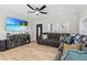 Inviting living room with a large TV, a comfortable sectional sofa, and modern decor at 4420 Pompano Se Dr, St Petersburg, FL 33705