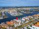 Aerial view of a waterfront home on a canal community with lush landscaping and boat docks at 861 Symphony Isles Blvd, Apollo Beach, FL 33572