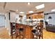 Basement bar with granite countertop, wooden cabinets, and four bar stools at 861 Symphony Isles Blvd, Apollo Beach, FL 33572