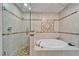 Bathroom featuring a soaking tub and separate shower with patterned tile at 861 Symphony Isles Blvd, Apollo Beach, FL 33572