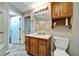 Well-lit bathroom features tile accents, a granite-topped vanity, and a storage cabinet at 861 Symphony Isles Blvd, Apollo Beach, FL 33572