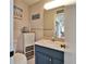 Cozy bathroom with blue vanity, tiled walls, and decorative nautical accents at 861 Symphony Isles Blvd, Apollo Beach, FL 33572