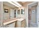 Traditional bathroom with a neutral color scheme, a large mirror, and a well-lit vanity area at 861 Symphony Isles Blvd, Apollo Beach, FL 33572