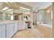 Bright bathroom with double sink vanity, tub, and glass block shower at 861 Symphony Isles Blvd, Apollo Beach, FL 33572