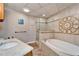 A bathroom with a shower, tub, decorative tile and granite countertop at 861 Symphony Isles Blvd, Apollo Beach, FL 33572