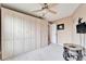Neutral bedroom with a large closet, ceiling fan, and mounted television at 861 Symphony Isles Blvd, Apollo Beach, FL 33572