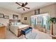 Comfortable bedroom with a bed, bench, and bright windows with a view at 861 Symphony Isles Blvd, Apollo Beach, FL 33572