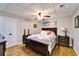 Bedroom with hardwood floors, a ceiling fan, and nautical-themed artwork at 861 Symphony Isles Blvd, Apollo Beach, FL 33572