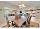 Elegant dining room with large mirror and open to the kitchen and living room at 861 Symphony Isles Blvd, Apollo Beach, FL 33572
