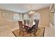 Elegant dining room featuring a large wooden table, seating for six, and decorative chandelier at 861 Symphony Isles Blvd, Apollo Beach, FL 33572