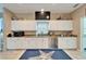 Bright kitchen with white cabinets, stainless steel appliances, and a large window above the sink at 861 Symphony Isles Blvd, Apollo Beach, FL 33572