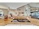 Granite countertops and glass cooktop in a kitchen open to a large dining area and living space at 861 Symphony Isles Blvd, Apollo Beach, FL 33572