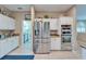 Modern kitchen featuring stainless steel appliances, tile flooring, and ample storage space at 861 Symphony Isles Blvd, Apollo Beach, FL 33572