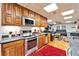 Modern kitchen featuring stainless steel appliances, granite countertops, and wood cabinets with great lighting at 861 Symphony Isles Blvd, Apollo Beach, FL 33572