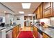 Well-lit kitchen with wooden cabinets, stainless steel appliances, and granite countertops at 861 Symphony Isles Blvd, Apollo Beach, FL 33572