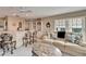 Sitting area with wet bar, couch, and a slider to patio with water view at 861 Symphony Isles Blvd, Apollo Beach, FL 33572