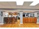 Spacious living space with hardwood floors, a kitchen with counter seating, and a comfortable seating area at 861 Symphony Isles Blvd, Apollo Beach, FL 33572