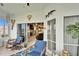 Enclosed patio featuring a tiled floor, seating, and nautical decor at 861 Symphony Isles Blvd, Apollo Beach, FL 33572