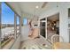 Screened-in porch featuring a hanging swing, views of the water, and tile flooring at 861 Symphony Isles Blvd, Apollo Beach, FL 33572