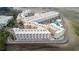 Aerial view of a coastal condominium complex with unique architecture, parking, and a swimming pool at 2506 N Rocky Point Dr # 272, Tampa, FL 33607