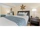 Comfortable bedroom featuring queen bed, stylish decor, and ample closet space at 2506 N Rocky Point Dr # 272, Tampa, FL 33607