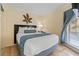 Cozy bedroom with queen bed, modern decor, and natural light from the window at 2506 N Rocky Point Dr # 272, Tampa, FL 33607