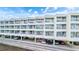Condominium exterior featuring balconies, parking, and waterfront views at 2506 N Rocky Point Dr # 272, Tampa, FL 33607